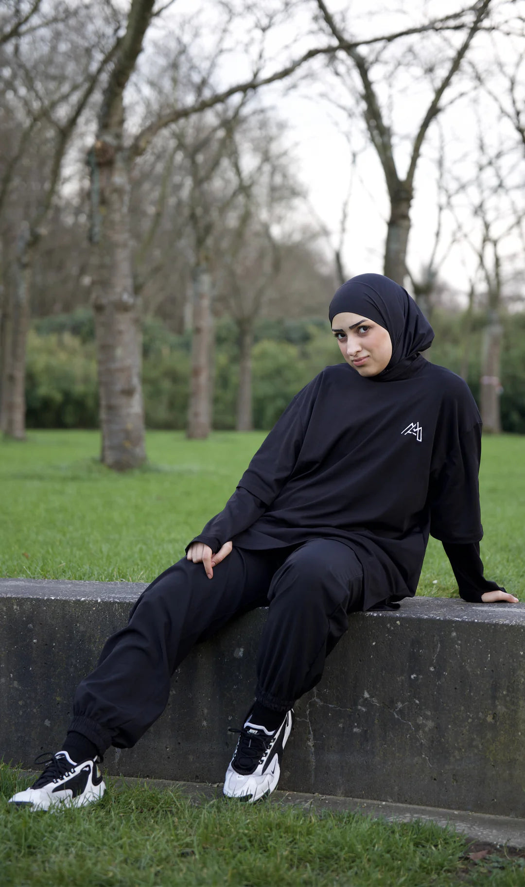Women in an Oversized Black Modest Tee, Trouser and an Instant Hijab with White Shoes