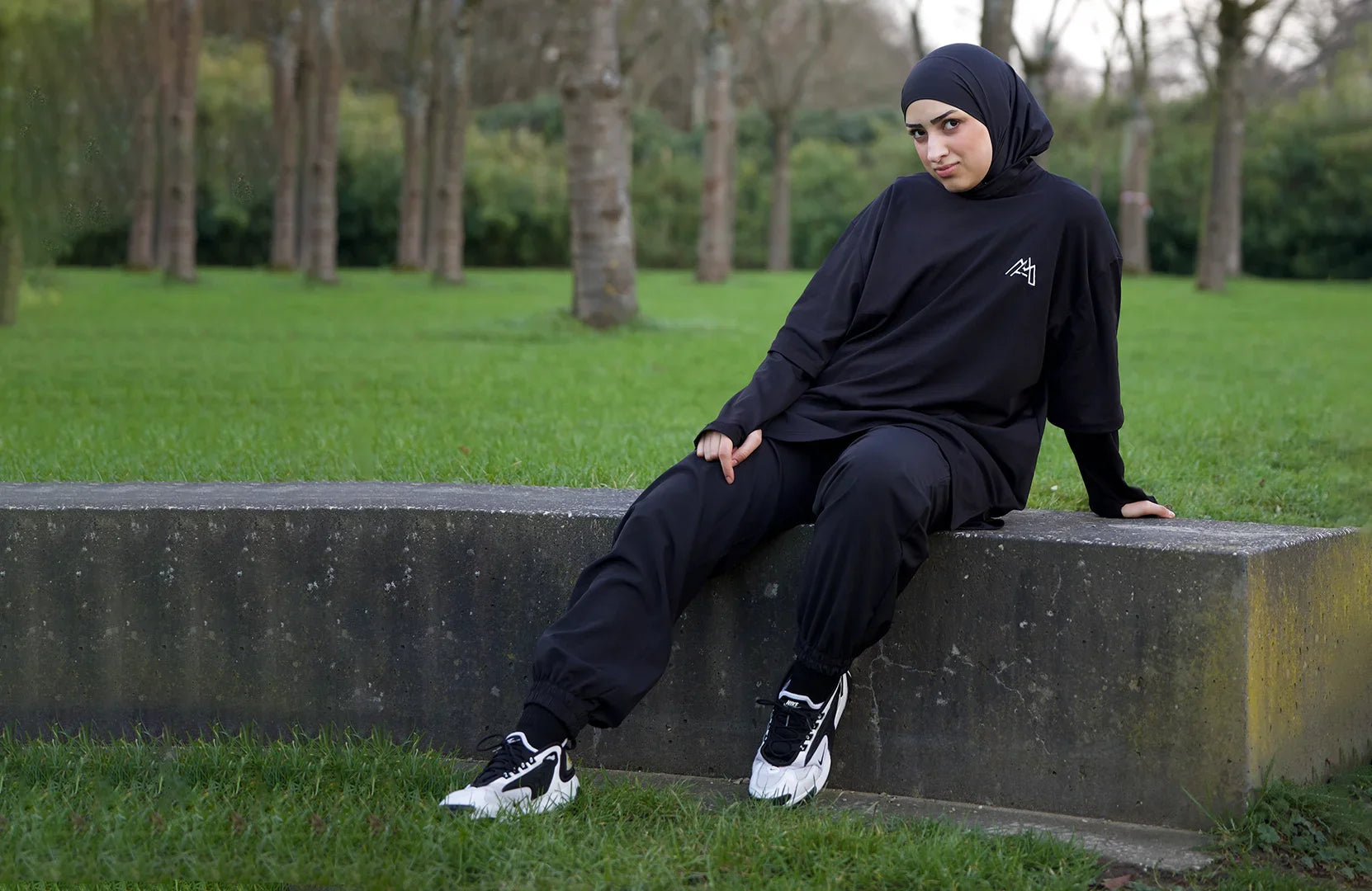 Women in an Oversized Black Modest Tee, Trouser and an Instant Hijab with White Shoes