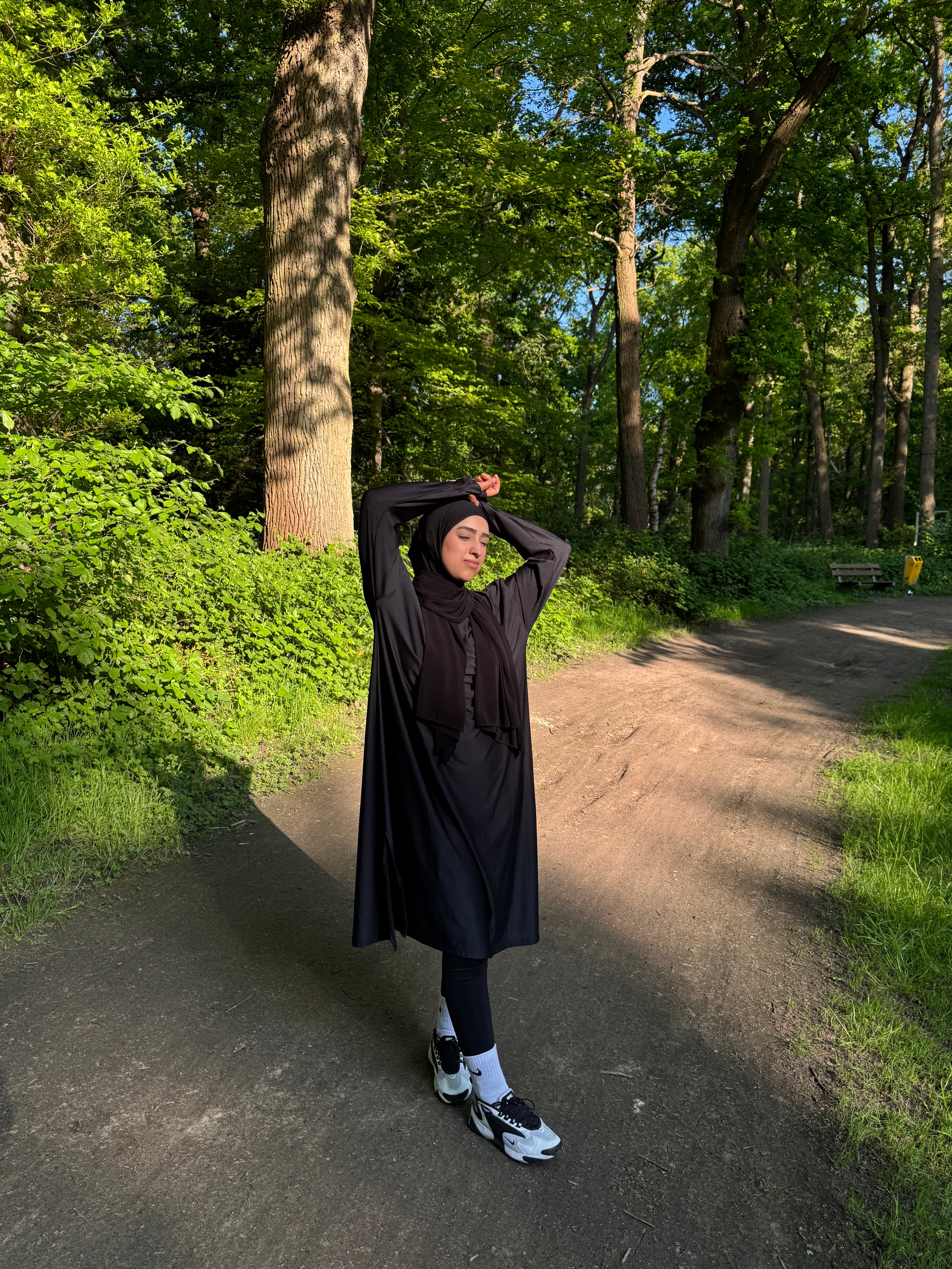 Muslim Woman Posing in the Sunlight in a Forest Wearing a Sports Abaya | Modest Outdoor Fashion