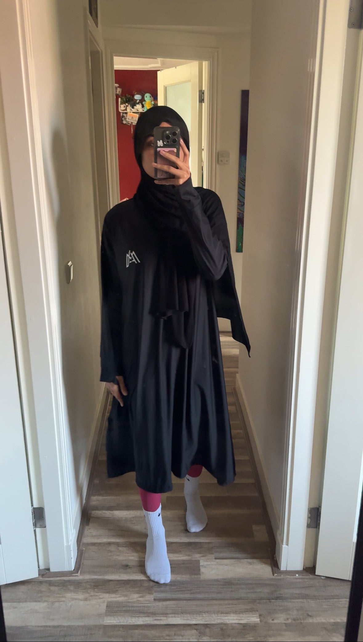 Muslim Woman Posing in Front of Mirror in Sports Abaya